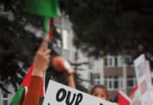 a sign that reads our voices will never be silenced israel