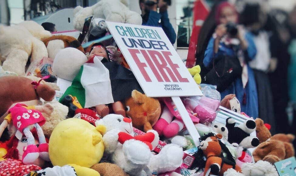 a pile of stuffed animals and a sign that says fire