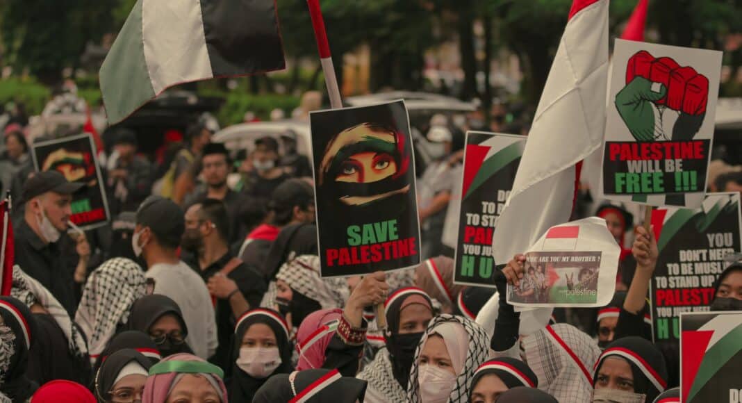 crowd of people protesting with banners