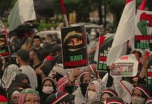 crowd of people protesting with banners