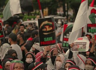 crowd of people protesting with banners