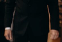 man standing next to the flag of israel