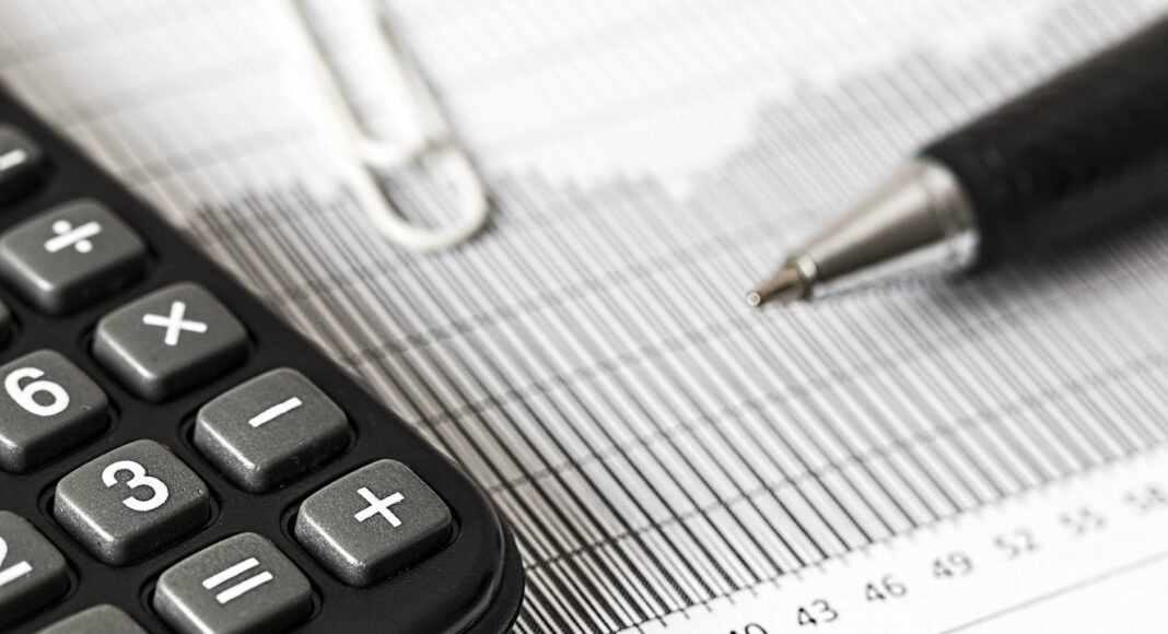 calculator and pen on table