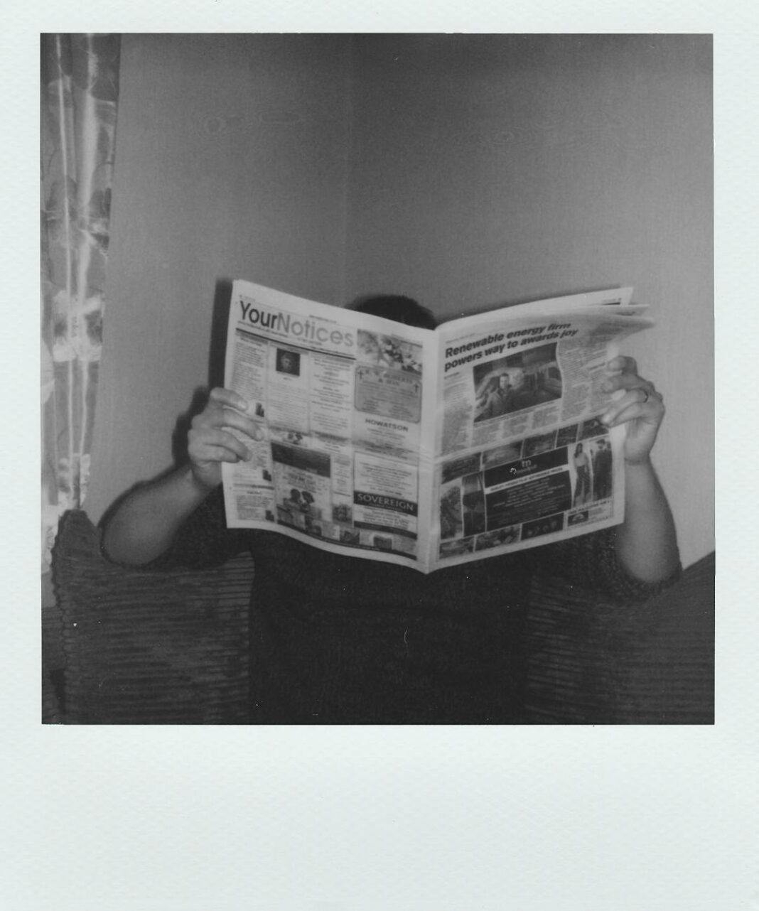 grayscale photography of man reading newspaper