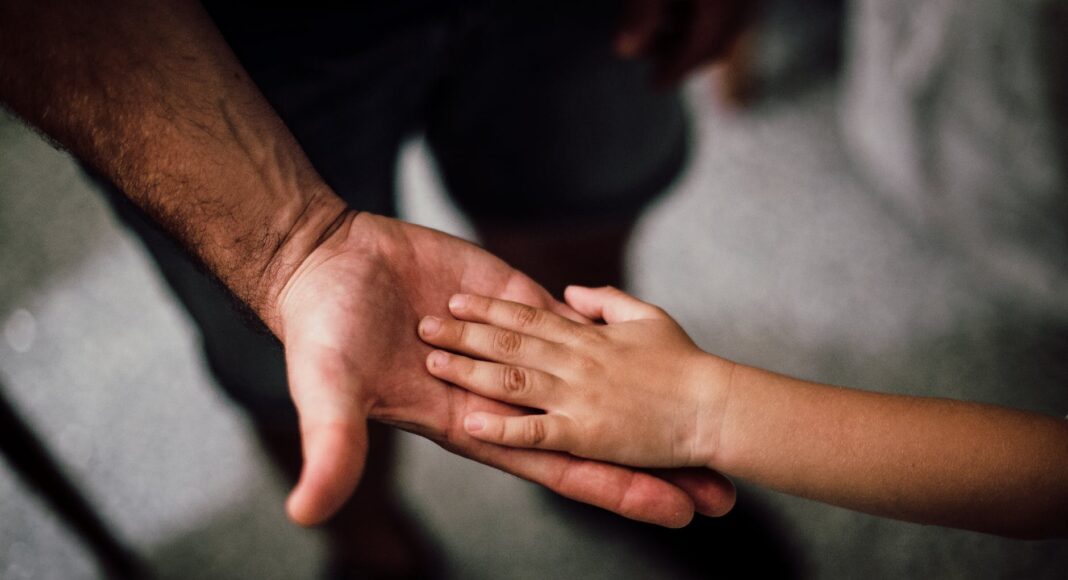 father and child s hands together