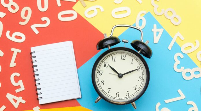 alarm clock lying on multicolored surface