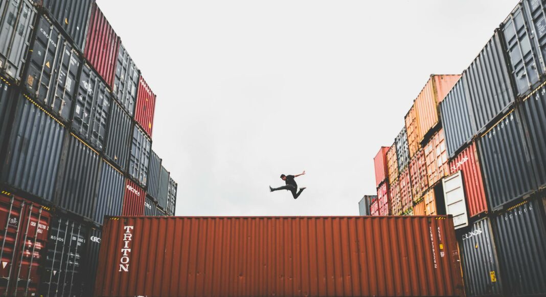 man jumping on intermodal container