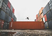 man jumping on intermodal container