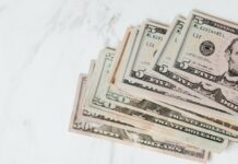 different dollar bills on marble surface