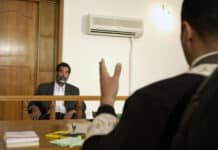 credit: Cullen/USAF/DOD. Former and deposed President of Iraq, Saddam Hussein, sits before an Iraqi judge at a courthouse in Baghdad, Iraq, where he has his initial interview to inform him of what he is being investigated for and his legal rights read to him.