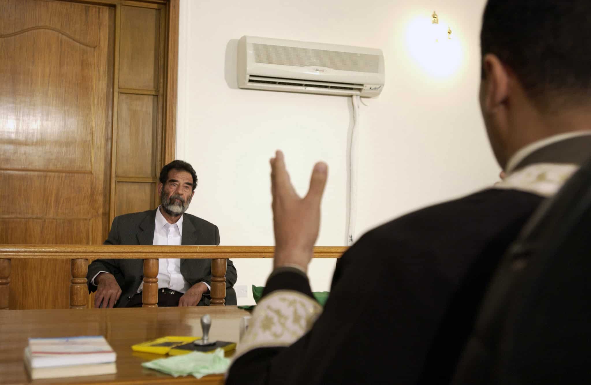 credit: Cullen/USAF/DOD. Former and deposed President of Iraq, Saddam Hussein, sits before an Iraqi judge at a courthouse in Baghdad, Iraq, where he has his initial interview to inform him of what he is being investigated for and his legal rights read to him.