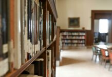 selective focus photography of bookshelf with books