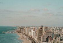 aerial photo of road near buildings and beach