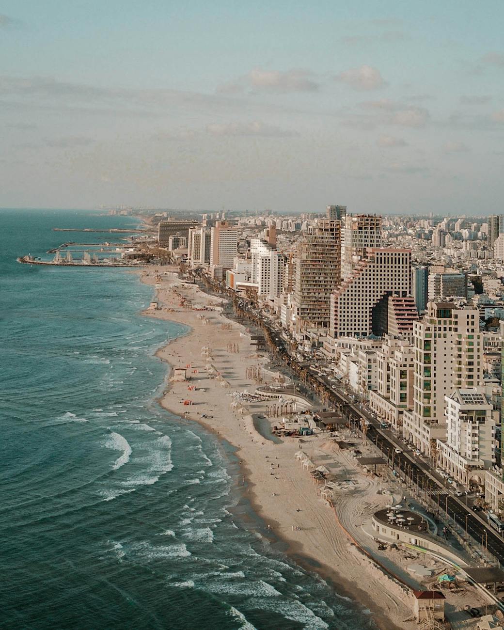 aerial photo of road near buildings and beach