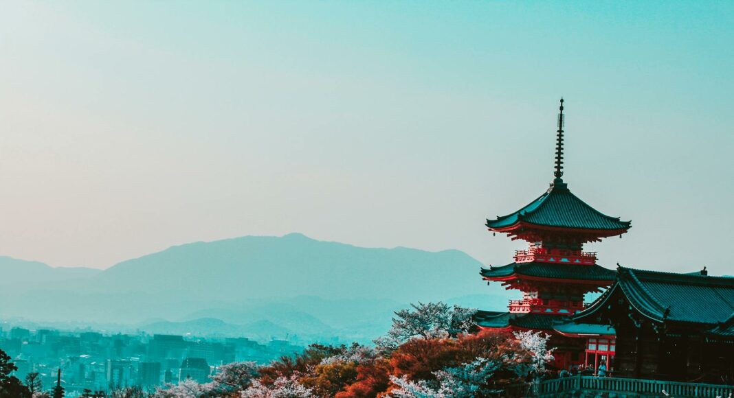 red and black temple surrounded by trees photo