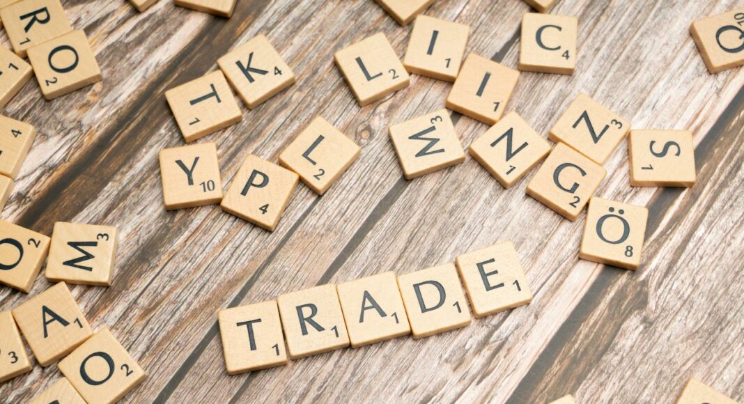 trade and trade related words on wooden table