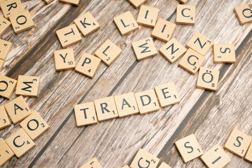 trade and trade related words on wooden table