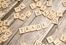 trade and trade related words on wooden table