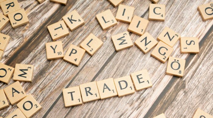 trade and trade related words on wooden table