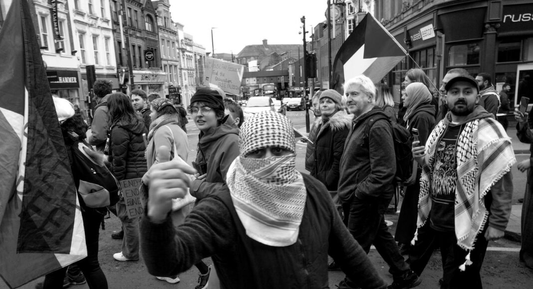 people protesting on street in black and white