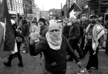 people protesting on street in black and white