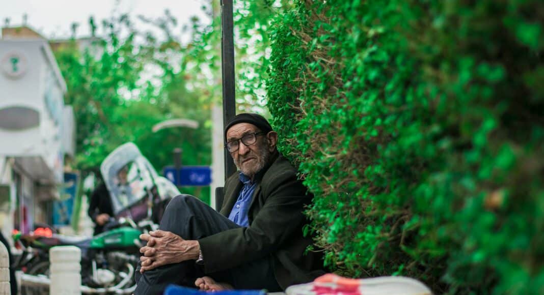 man in black long sleeve shirt sitting on floor