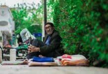 man in black long sleeve shirt sitting on floor