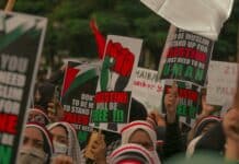 protesters holding posters during their rally