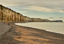 brown rocky mountain near the ocean