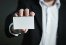 close up of hand holding text over black background