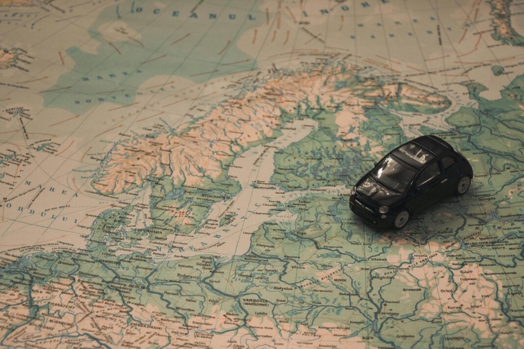 pexels-photo black toy car on world map paper