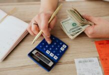 woman calculating money and receipts using a calculator
