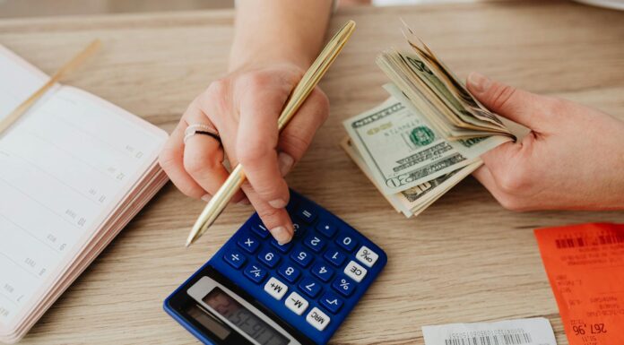 woman calculating money and receipts using a calculator