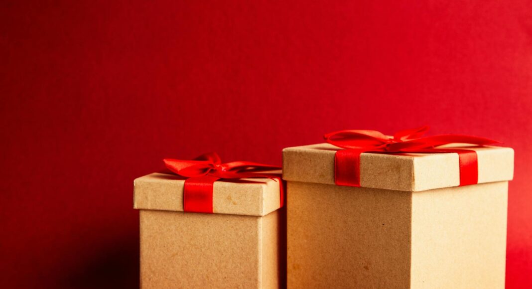 two brown and red gift boxes on red surface