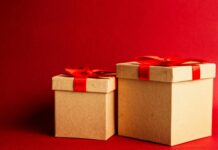 two brown and red gift boxes on red surface