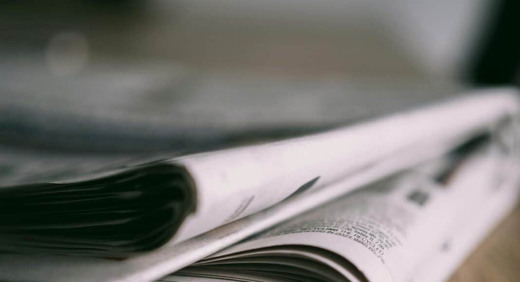 close up of newspapers on wooden table