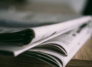 close up of newspapers on wooden table