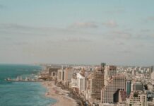 aerial photo of road near buildings and beach