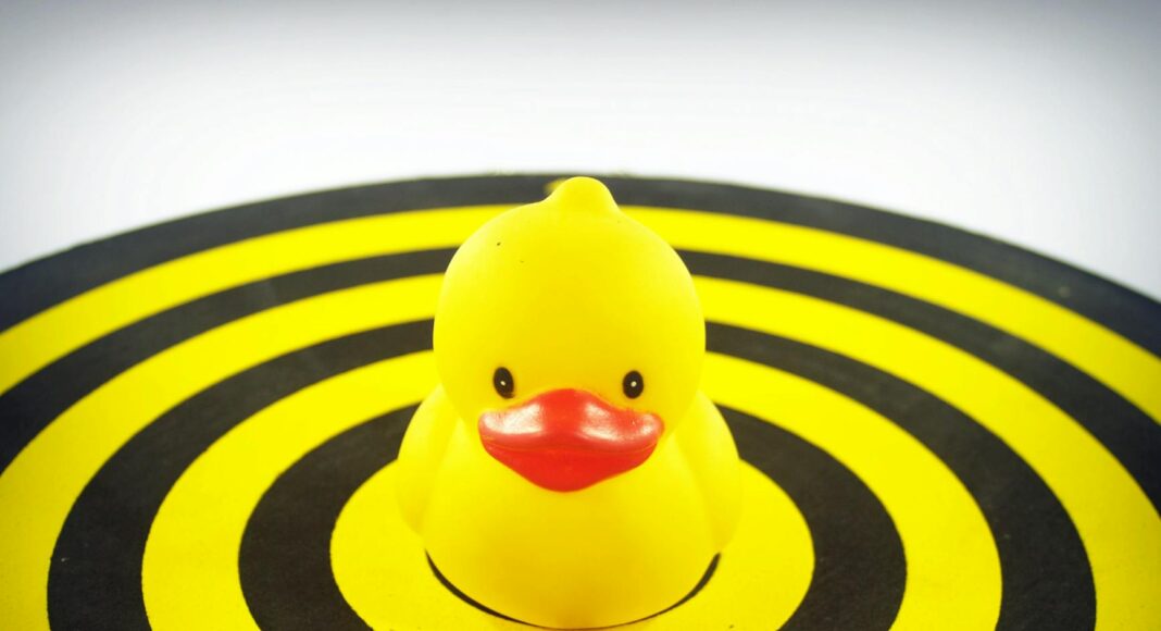 yellow rubber duckie on dart board