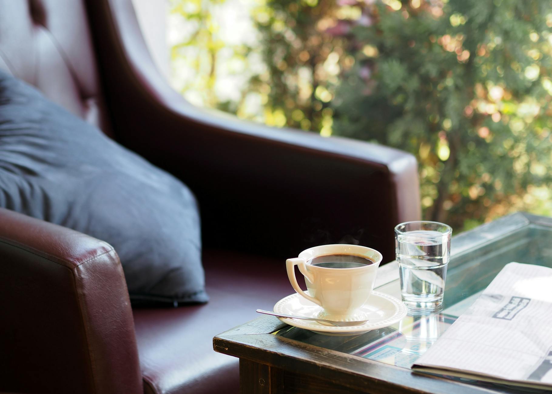 filled white coffee cup on saucer
