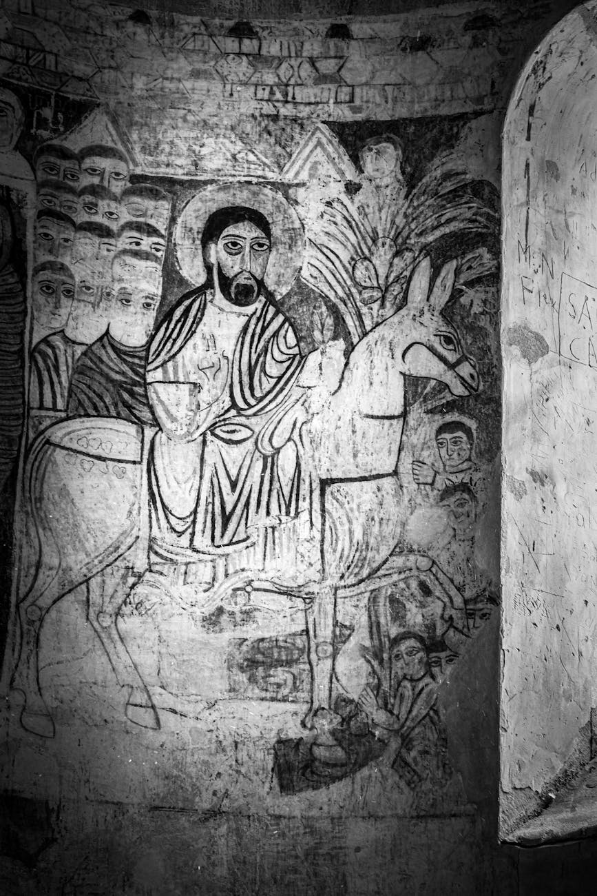 a black and white photo of a man riding on a donkey