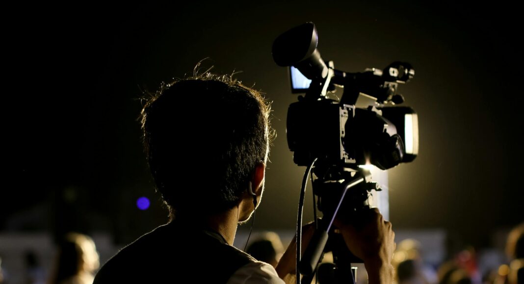 shallow focus photo of cameraman