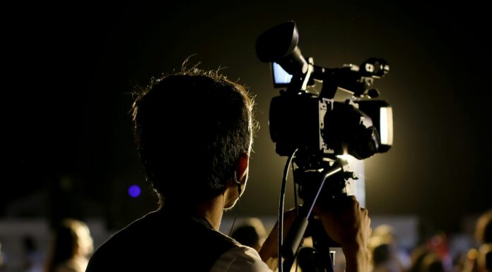 shallow focus photo of cameraman