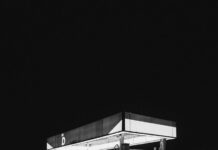 grayscale photo of a gas station