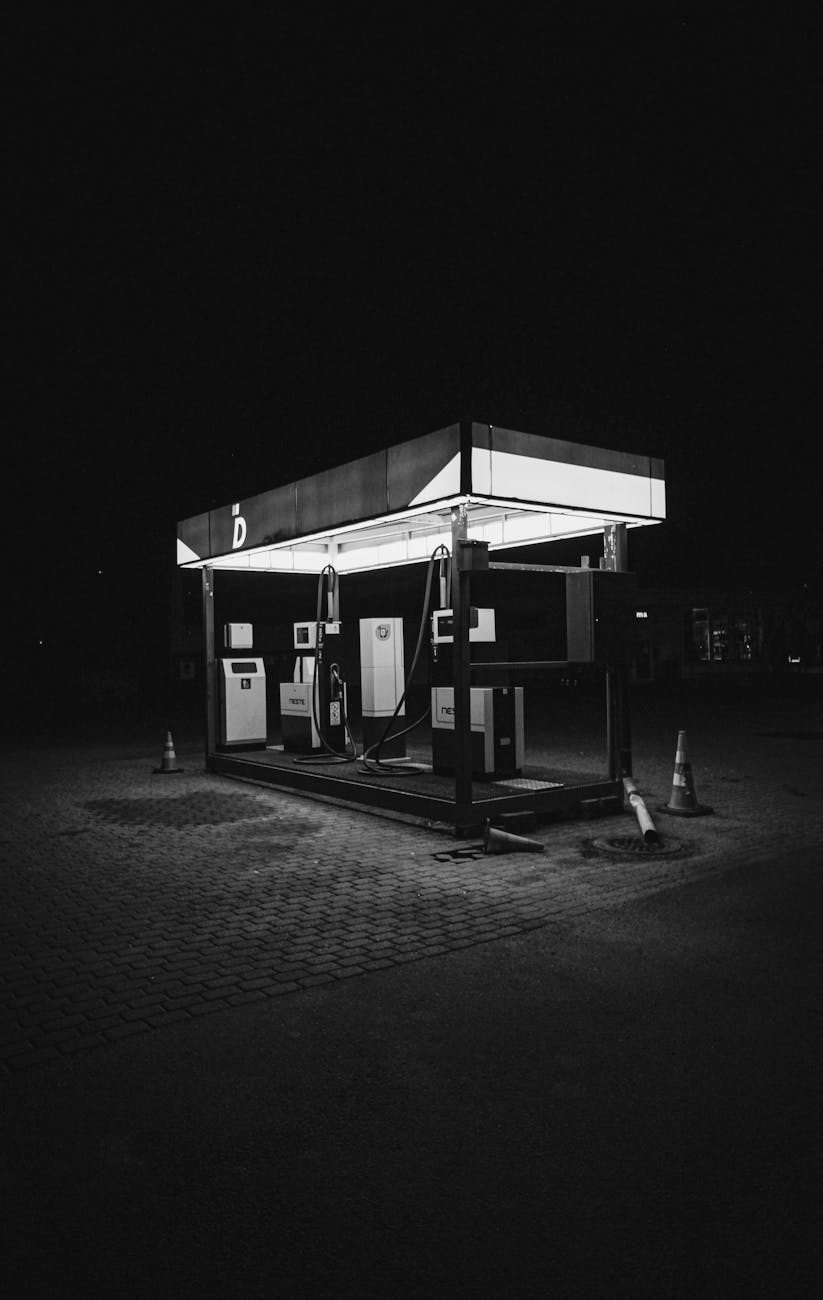 grayscale photo of a gas station