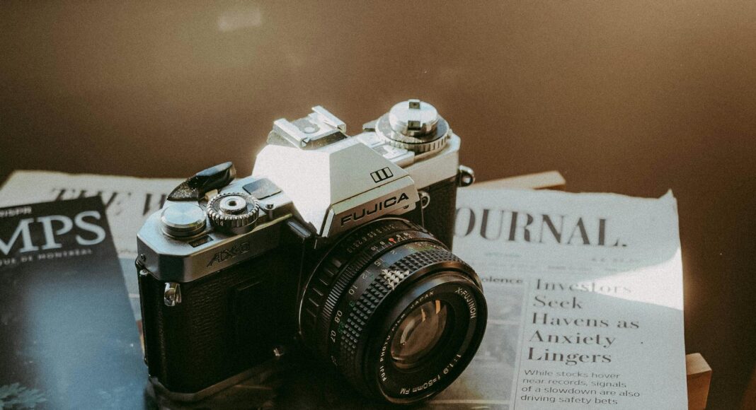 vintage fujica camera on top of a newspaper