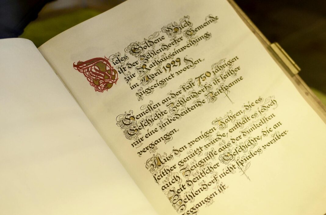 old opened book with calligraphic inscription