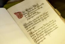 old opened book with calligraphic inscription