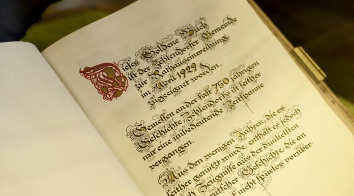 old opened book with calligraphic inscription