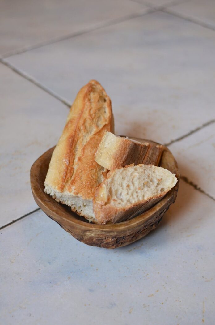 fresh cut bread in wooden bowl